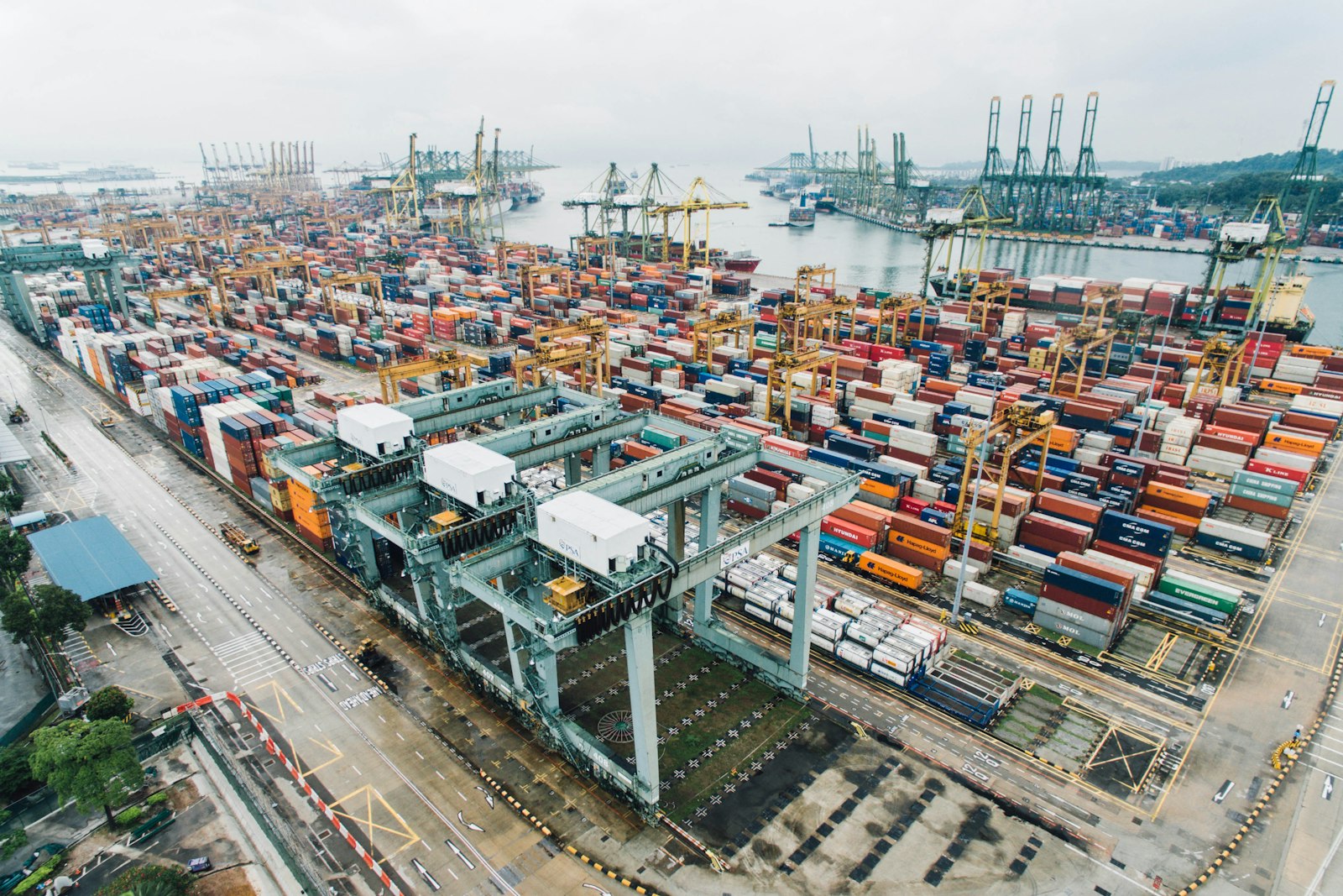 Aerial view of a container terminal with cranes and stacked cargo